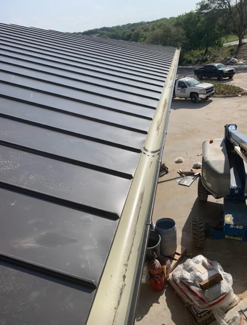 Standing seam panel and gutter detail on a metal roofing jobsite in Seabrook